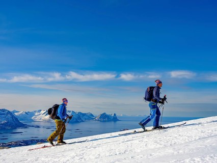 Mountain guide with his guest ascending onto the Bergsfjord with skis