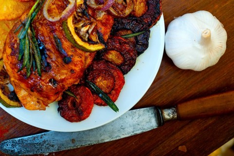 Roasted grilled BBQ chicken breast with herbs and spices rustic style