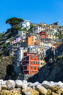 The village of Riomaggiore with its nested pastel-coloured houses built into the hillside