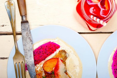 Sea bream orata fillet butter pan fried with fresh peach prune and dragonfruit slices thyme on top