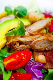 Fresh and healthy Chicken Avocado salad over rustic wood table