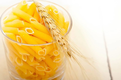 Short Italian pasta penne with durum wheat grains