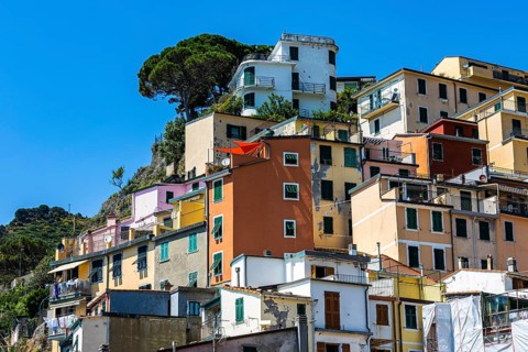 The village of Riomaggiore with its nested pastel-coloured houses built into the hillside