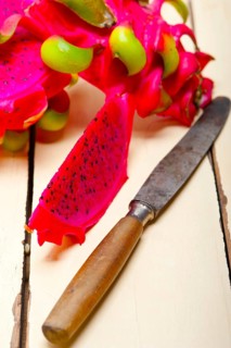 Fresh thai purple dragon fruit over white rustic table