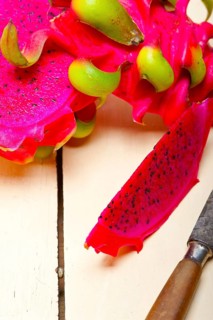 Fresh thai purple dragon fruit over white rustic table