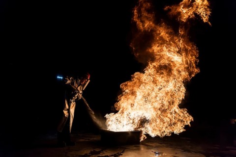 Firefighter extinguishes a heptane 2B-Pan fire with a 2-BTP extinguisher