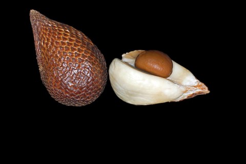 One whole and one halved and peeled salak