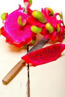 Fresh thai purple dragon fruit over white rustic table