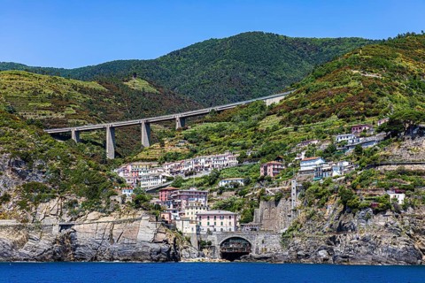 The village of Riomaggiore with its nested pastel-coloured houses built into the hillside