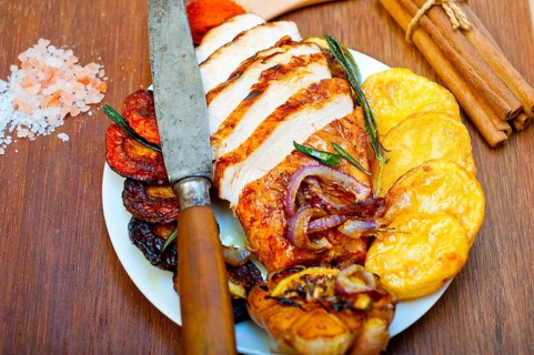 Roasted grilled BBQ chicken breast with herbs and spices rustic style