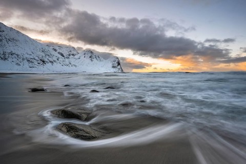 Beach with waves at sunset