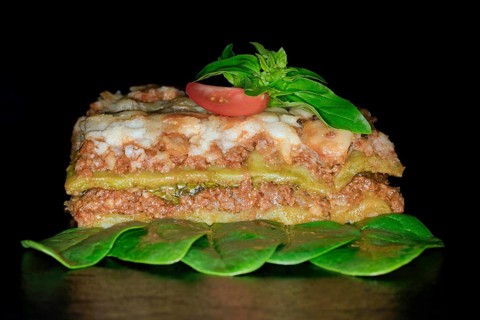 Classic lasagne with spinach leaves