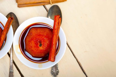 Poached pears delicious home made recipe ove white rustic wood table