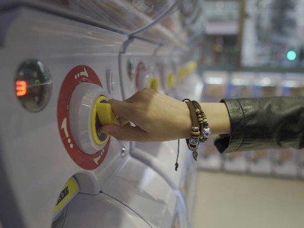 Hand using toy vending machine