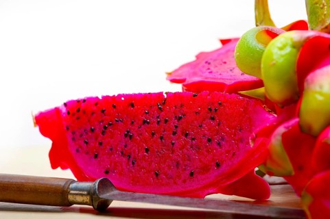 Fresh thai purple dragon fruit over white rustic table