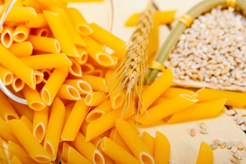 Short Italian pasta penne with durum wheat grains