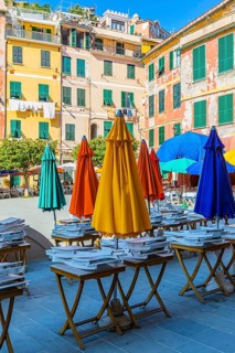 Coloured parasols of a closed restaurant at the main square of Vernazza