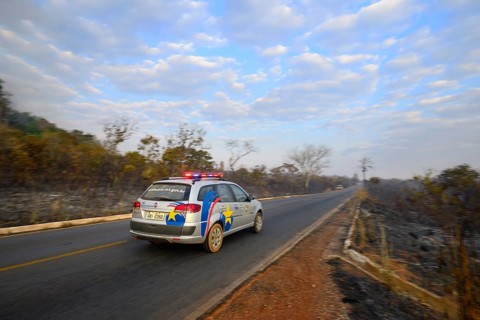 Military police vehicle on the main road 251 during a bush fire