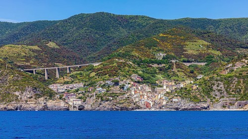 The village of Riomaggiore with its nested pastel-coloured houses built into the hillside