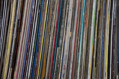 Old long-playing records stand on a shelf
