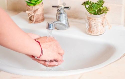 Close up of a person washing their hands with soap