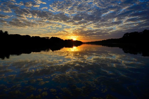 Sunrise with clouds reflected in Rio Sao Lourenco