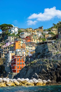 The village of Riomaggiore with its nested pastel-coloured houses built into the hillside