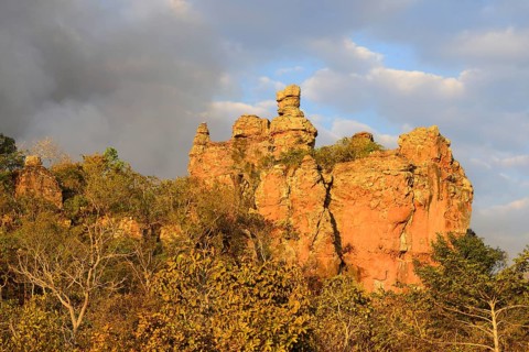 Bizarre rock formation and clouds of smoke during a bushfire