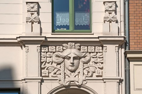 Art Nouveau ornament above a restored entrance to a town house