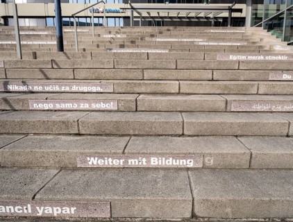 Stairway steps with slogans on the subject of education in several languages