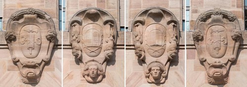 Four heraldic cartouches on the main facade of the courthouse