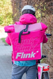 Delivery driver from the delivery service Flink with bicycle