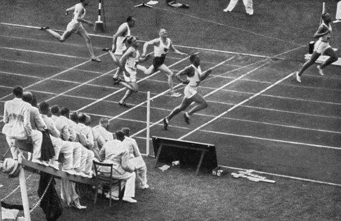 Jesse Owens tears the finish tape in the 100 m