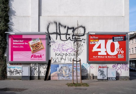 Large advertising posters for the delivery service Flink and Moebel Hoefner on a house wall