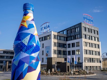 Oversized mineral water bottle in front of the building of the pharmaceutical company Stada Arzneimittel AG