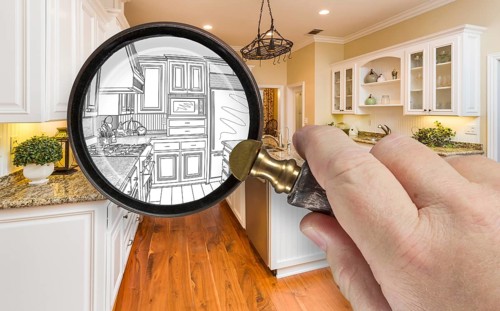 Hand holding magnifying glass revealing custom kitchen design drawing and photo combination