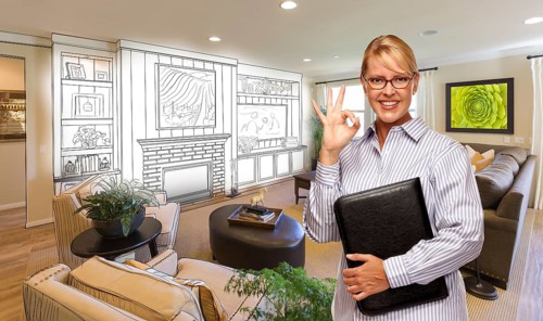 Happy woman with okay sign over custom living room and design drawing