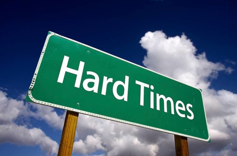 Hard times road sign with dramatic clouds and sky