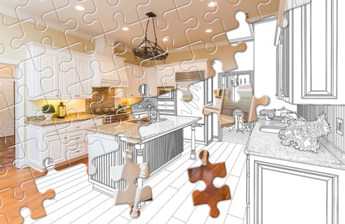 Puzzle pieces fitting together revealing finished kitchen build over drawing