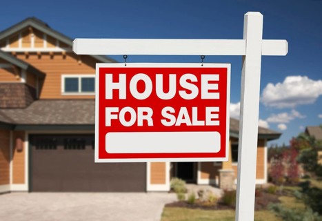 Home for sale sign in front of new house