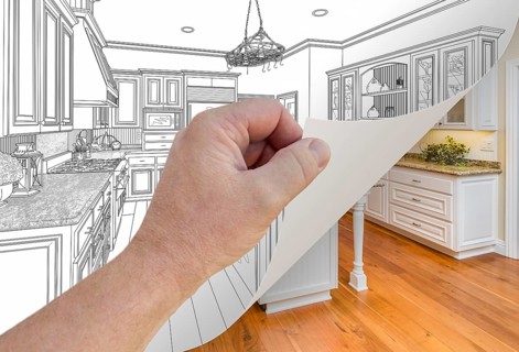 Male hand turning page of custom kitchen drawing to finished photograph underneath