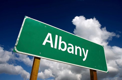 Albany road sign with dramatic blue sky and clouds