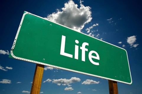 Life road sign with dramatic clouds and sky