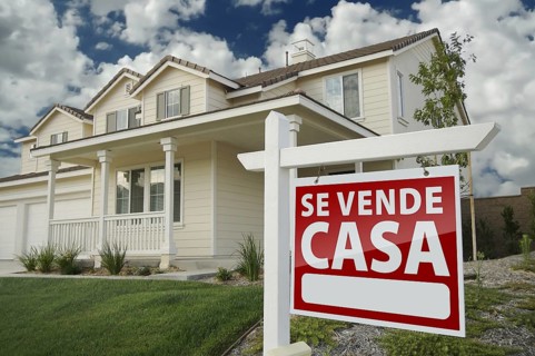 Home for sale real estate sign in front of new house