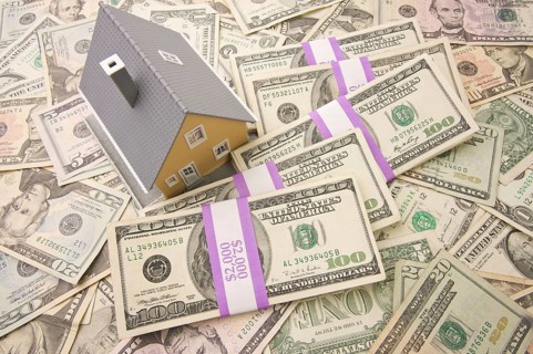 Home with stacks of money as background