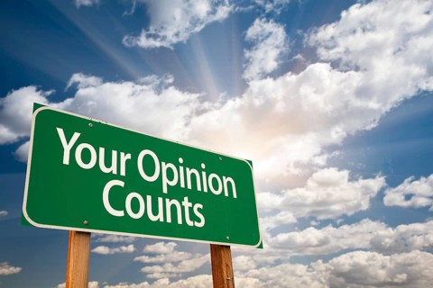 Your opinion counts green road sign with dramatic clouds and sky