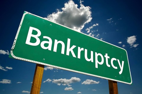 Bankruptcy road sign with dramatic clouds and sky