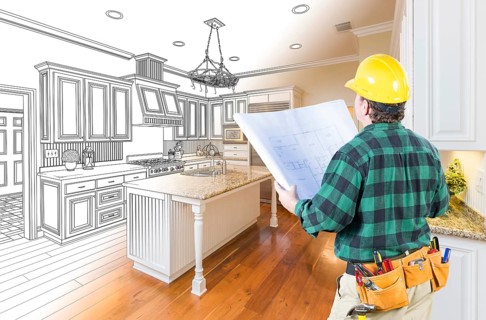 Male contractor with hard hat and plans looking at custom kitchen drawing photo combination on white