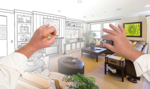Male hands drawing custom living room design gradating into photograph