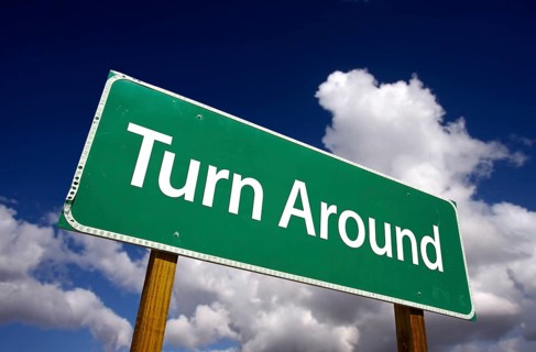 Turn around road sign with dramatic clouds and sky